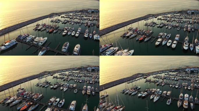 空中无人机镜头: 乘坐不同大小的游艇飞越滨海湾。停放的豪华游艇和渔船