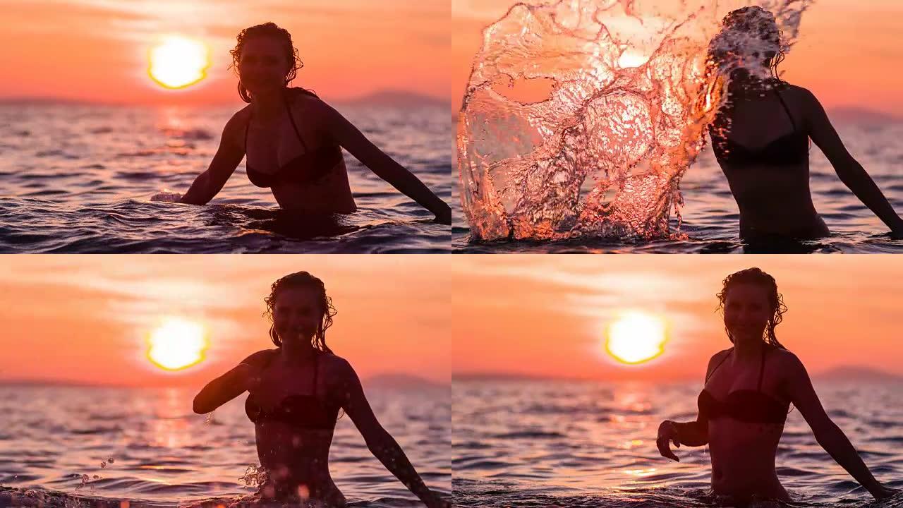 开朗的女人在日落时向相机泼水