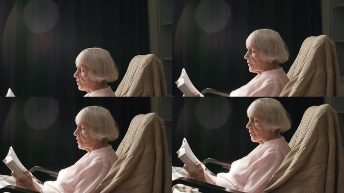 资深女性在椅子上放松阅读
