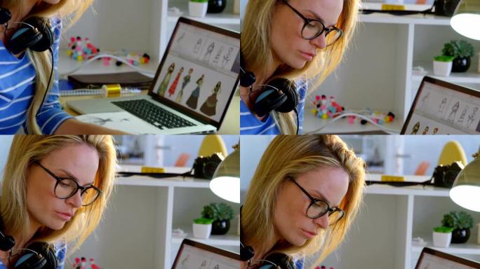 白人女性时装设计师在办公室4k办公桌上使用图形平板电脑的侧视图