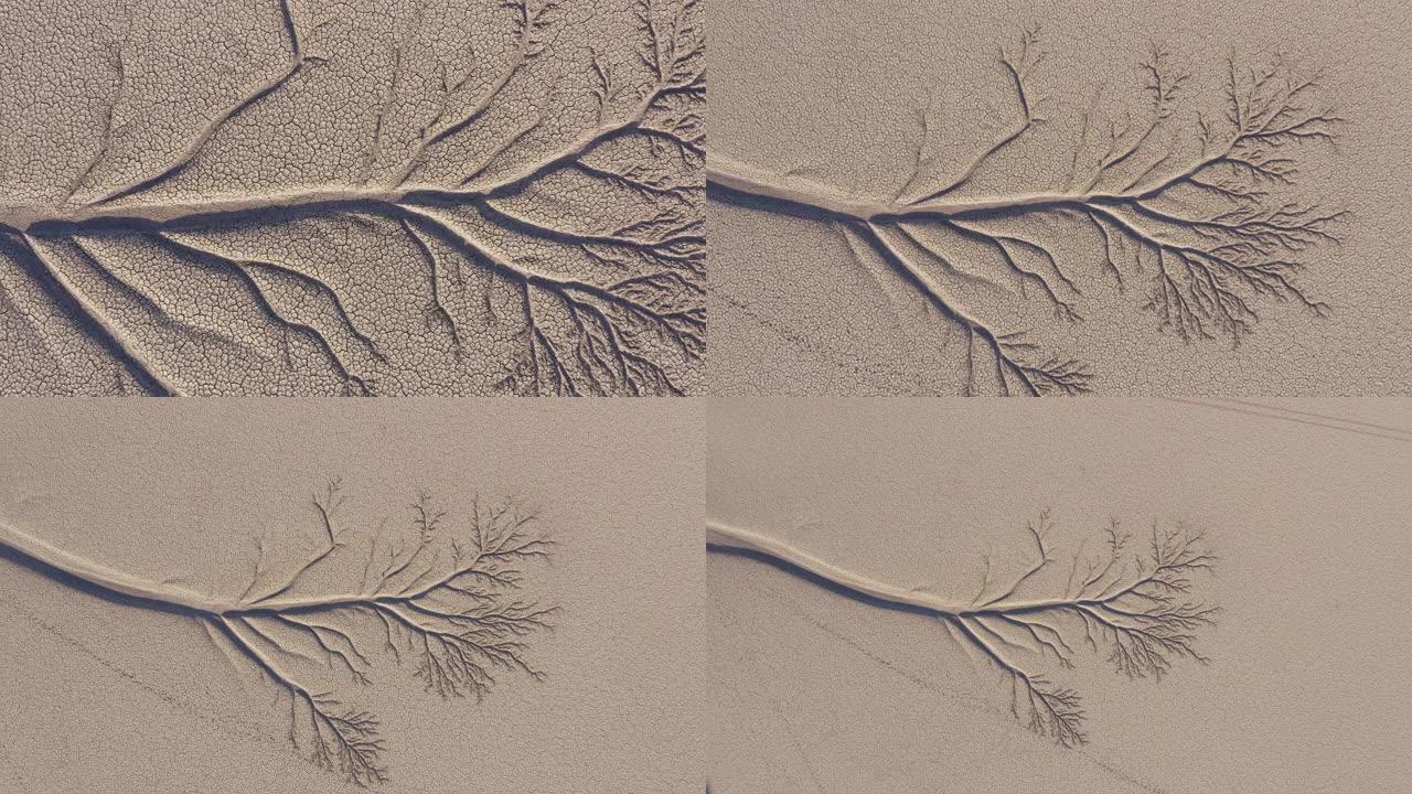 4k空中缩小视图由于气候变化和全球变暖造成的干旱大坝破裂的泥浆表面的美丽图案