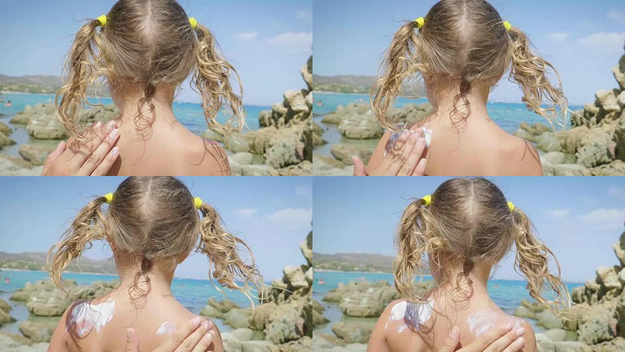 美丽的小女孩在海上玩耍的肖像，在巴拿马可爱的微笑，防晒霜，海蓝色的水和岩石的背景。