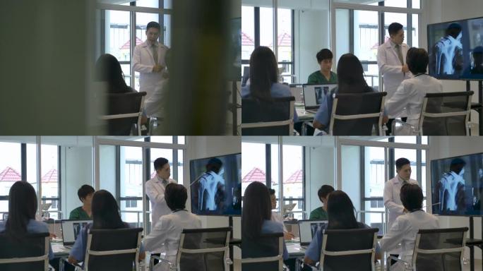 4k亚洲医生团队在会议室开会，他们正在讨论患者的x射线检查结果并寻求诊断。
