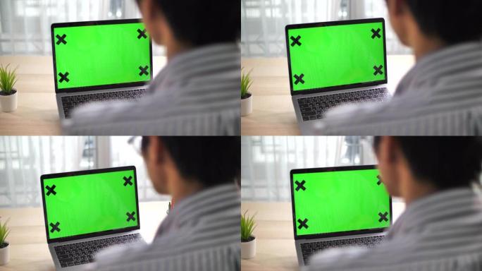 商人在绿屏笔记本电脑上工作