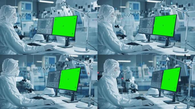 研究工厂洁净室: 穿着工作服和手套的工程师/科学家的特写镜头使用显微镜，计算机显示色度键/绿屏显示。