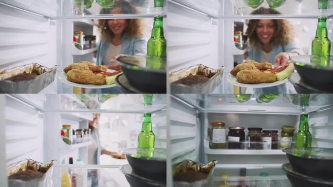 当女人开门时，从装满外卖食品的冰箱里眺望