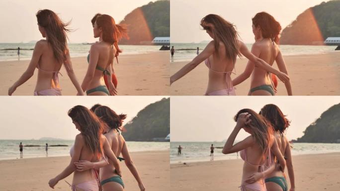 三个美丽的女孩在夏天在海滩上玩得开心，一群年轻的女人在海滩上穿着性感的小比基尼，假期玩得开心。假期-