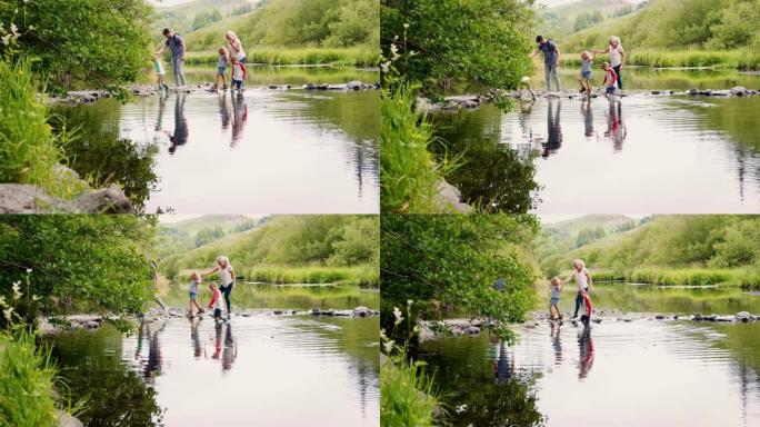 在英国湖区徒步旅行时，父母帮助孩子过河的慢动作镜头