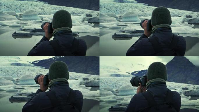 摄影师在冰川泻湖。日落