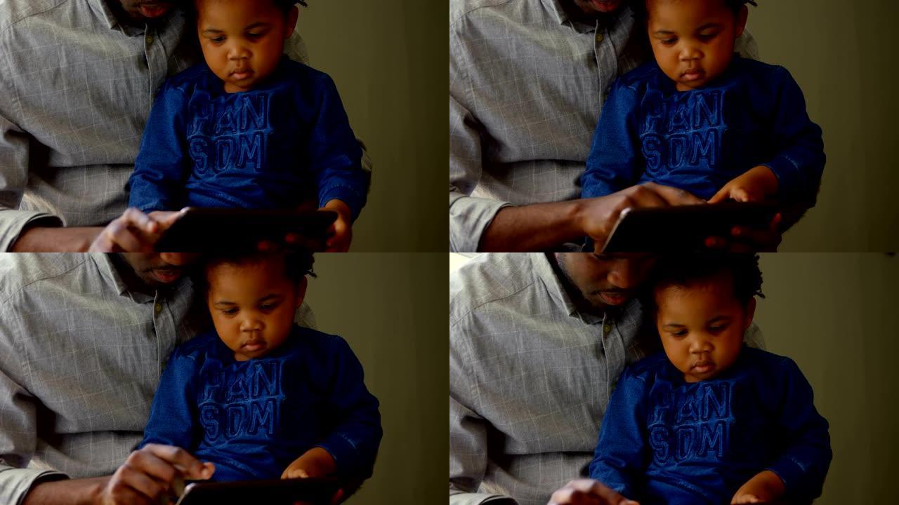 黑人父子在舒适的家庭4k中使用数字技术的前视图
