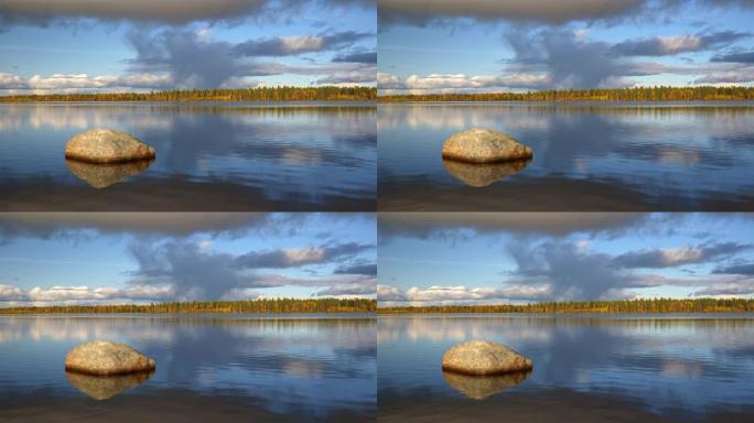 芬兰禅宗景观。湖中流动的水。阳光和水反射在石头上。风景如画的天空，背景是美丽的云彩。4K