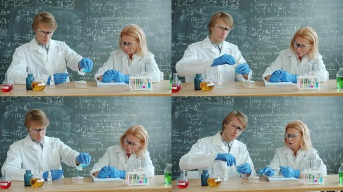 男女科学家在教室里忙于化学实验