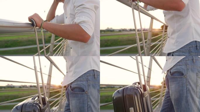 特写: 年轻人在等待飞行时观察早晨的风景。