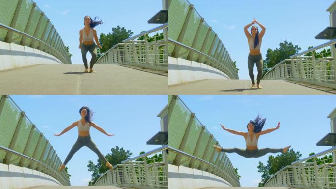 年轻的女舞者在城市4k的一座桥上跳舞