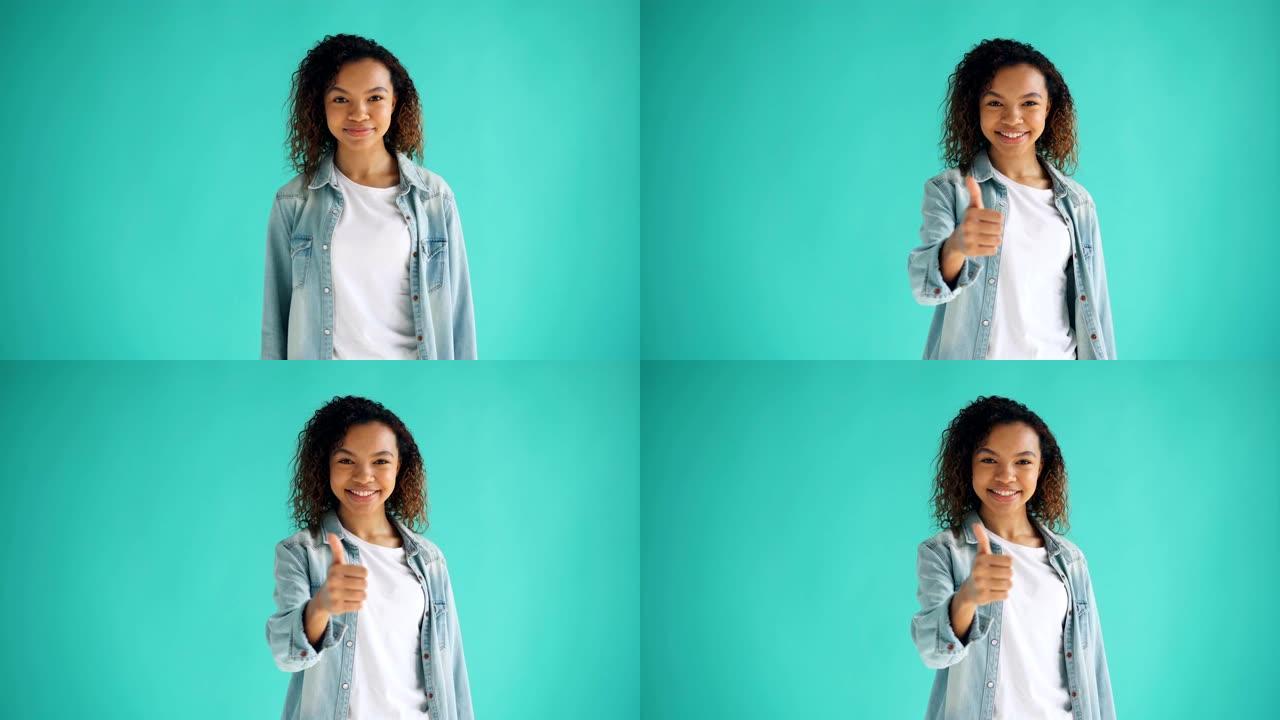 快乐的非洲裔美国女孩的肖像表现出竖起大拇指和微笑