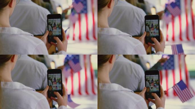 女商人在一场4k的政治竞选中用手机点击扬声器的照片