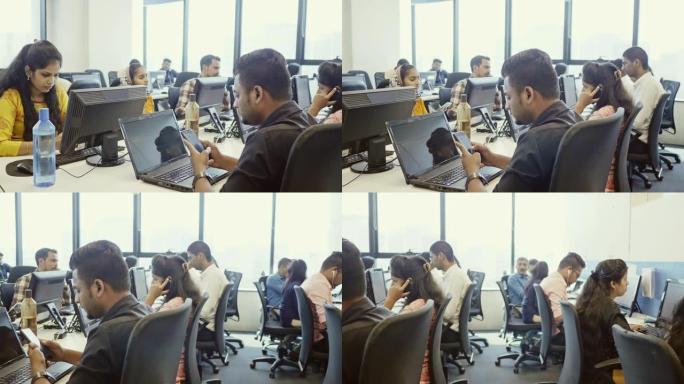 在办公室工作的印度男女专业人员的平移视频