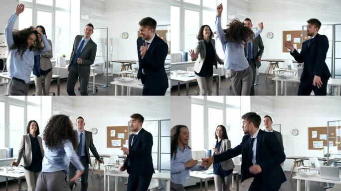 兴奋的同事一起在办公室跳舞