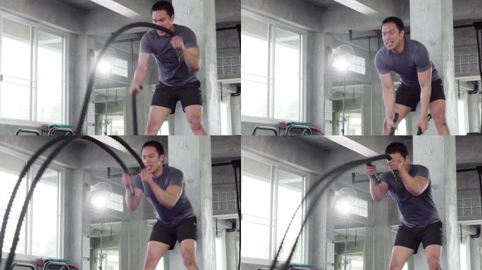 运动的人在健身房做战斗绳运动