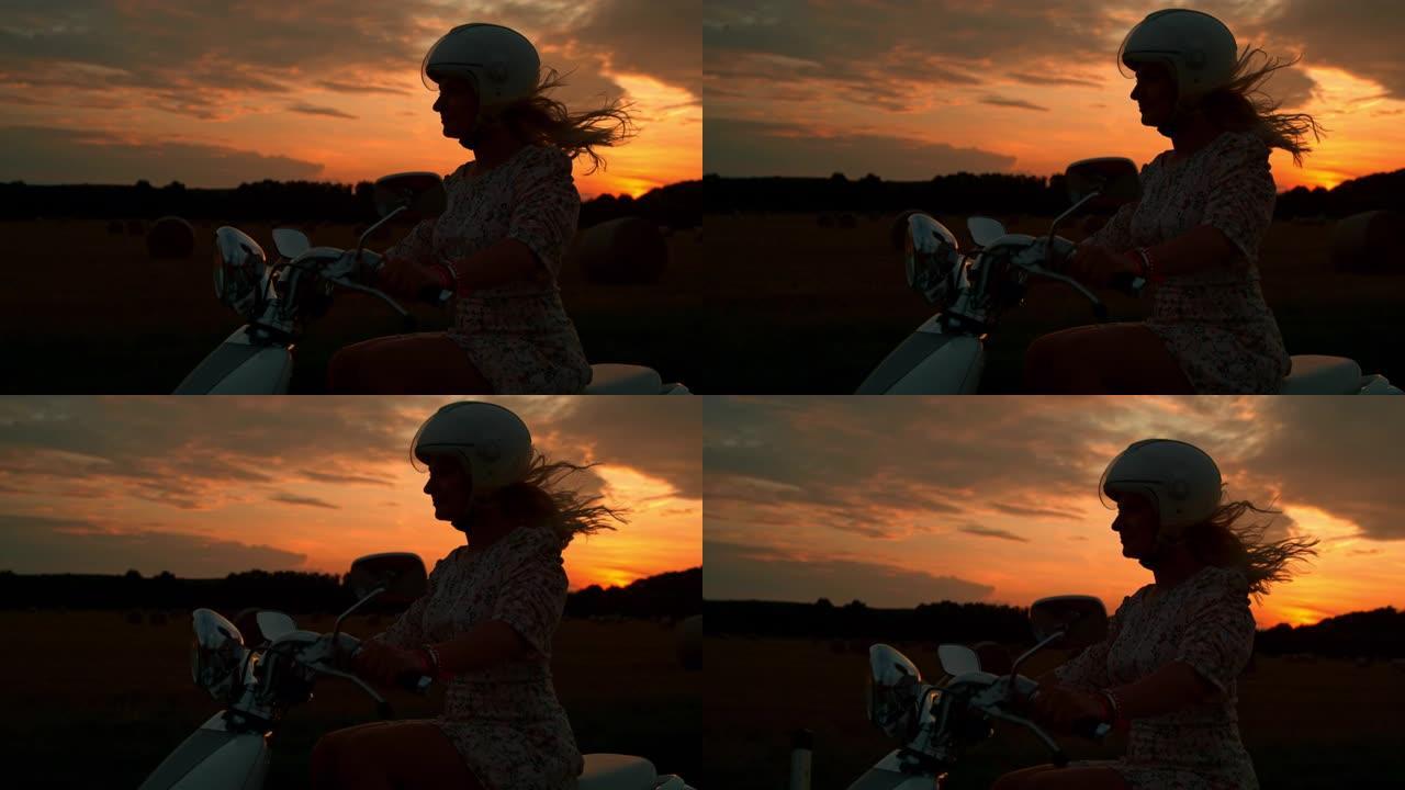日落时骑踏板车的女人的时间扭曲剪影
