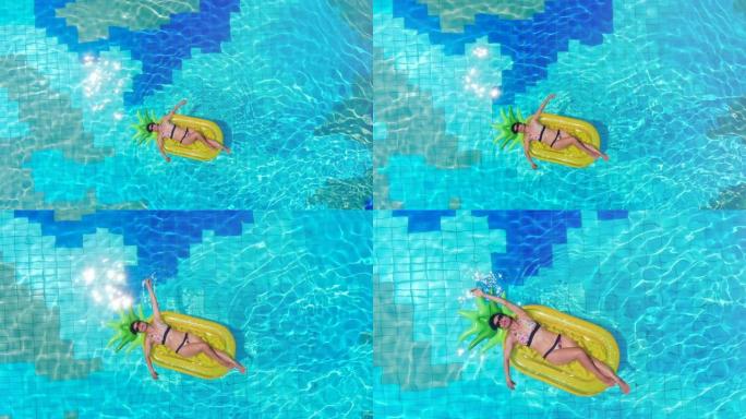 一个女孩躺在游泳池的橡胶床垫上。海上豪华度假概念。