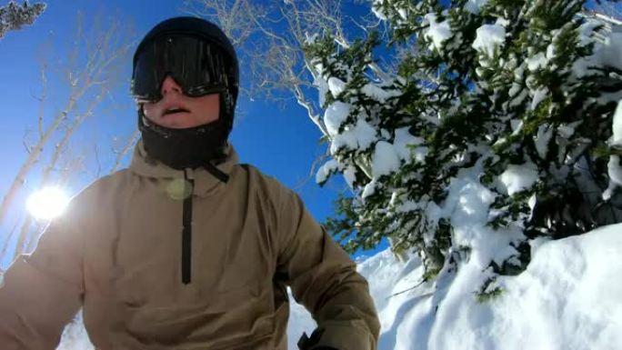 POV极端自由式滑雪者在阳光明媚的冬日骑在陡峭的山上