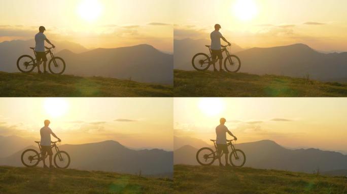 无人机: 越野自行车手在山上骑行后观看日落。
