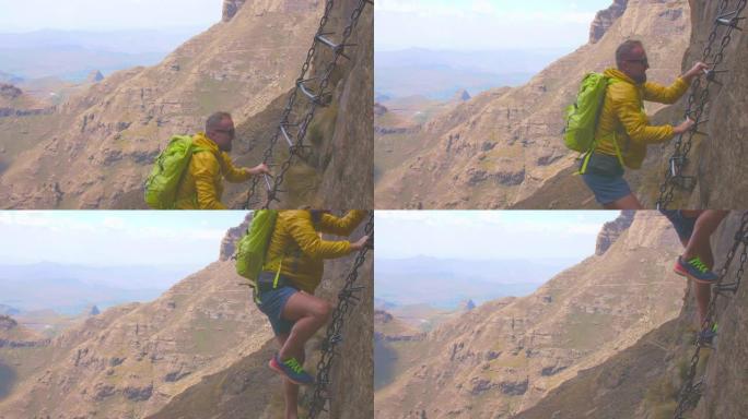 男子攀登高山铁索爬山