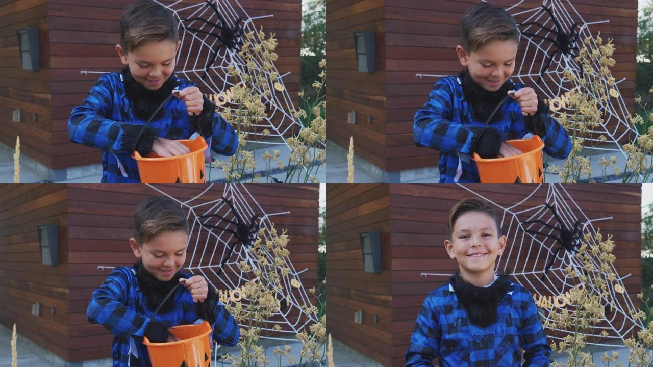 穿着化装的男孩肖像狼人服装在屋外收集糖果给捣蛋