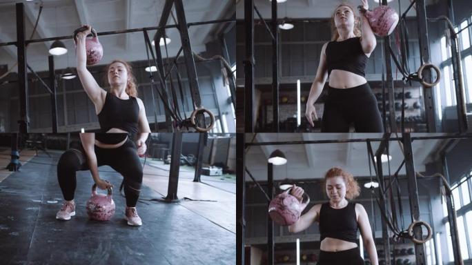 年轻漂亮的运动红头发女人举起壶铃的重量，在大型健身房做功能性训练锻炼。