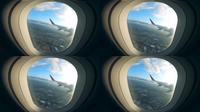 在城市上空飞行时从窗户看到飞机机翼