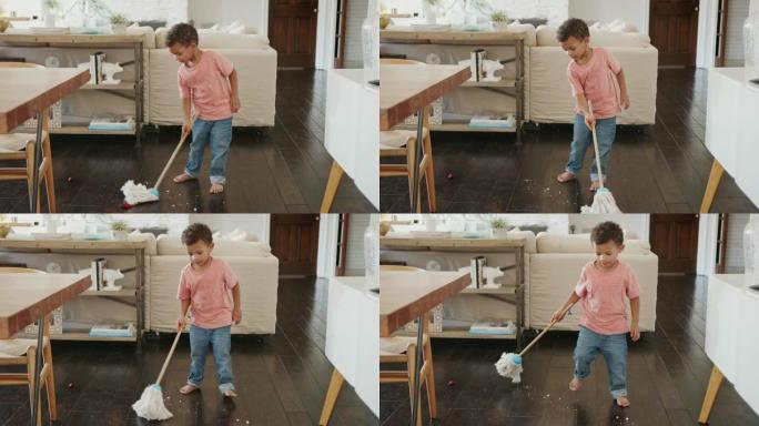 三岁的黑人男孩用拖把清洁餐厅地板，全长