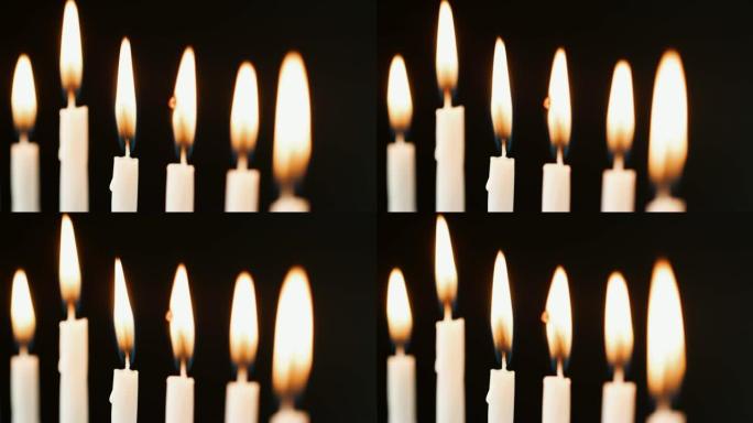 特写六支点燃的白色蜡烛连续燃烧，机架拍摄