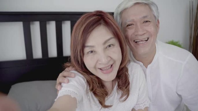 4k分辨率快乐亚洲老年夫妇生活方式技术设备概念，观点ovely老年视频打电话给他们的家人
