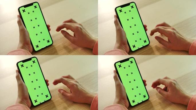 特写女人手用智能手机绿屏