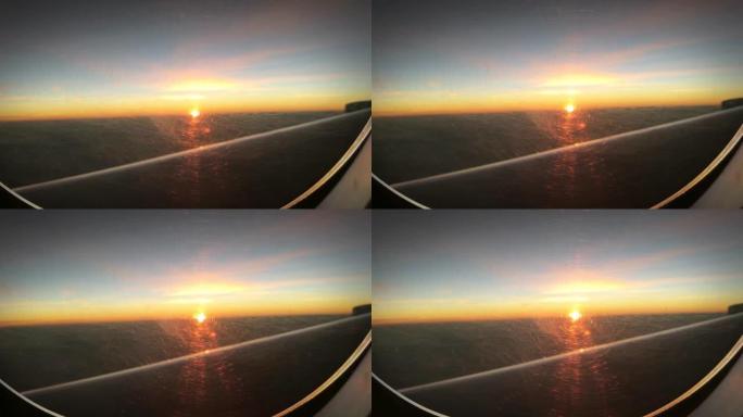 飞越日落。飞机窗户上的日落天空。