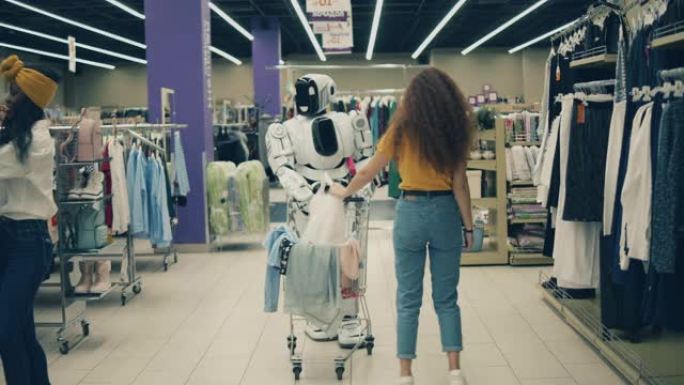 两个漂亮的女人正在和一个类似人类的机器人一起购物。购物快乐，有趣。