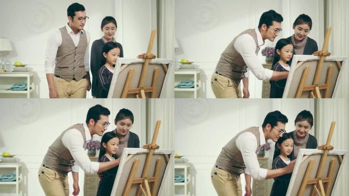 亚洲小女孩一边画画，一边看着父母
