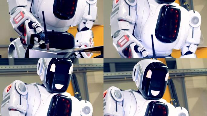 工业类人机器人与焊接机一起工作，特写。