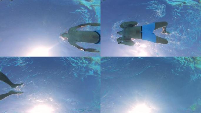 男性游泳运动员从水下射击