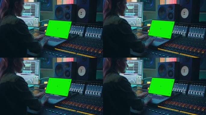 女艺术家，音乐家，制作人，音频工程师在音乐唱片工作室工作，制作新专辑，使用绿屏笔记本电脑，控制台进行