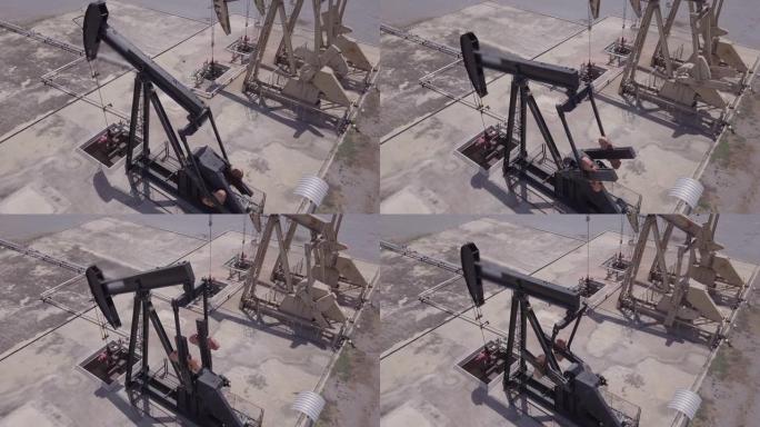 无人机飞行经过工作泵千斤顶工业油泵千斤顶在油田用钻机工作和泵送化石燃料能源的原油