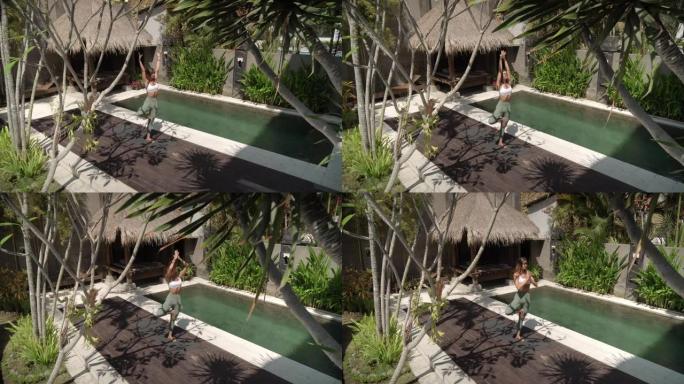 在热带后院花园做瑜伽锻炼的女人