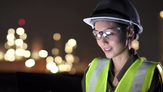 亚洲女工程师在夜间在工业，石油或天然气厂使用平板电脑