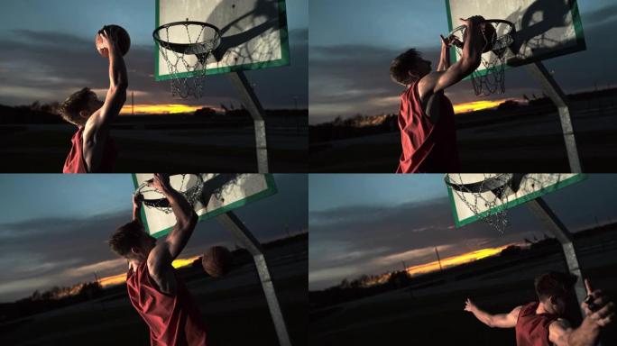 MS超级慢动作年轻人在黄昏时在篮球架上扣篮