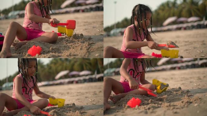 一个女孩在沙滩上玩玩具的特写镜头