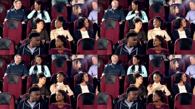 多种族的成年人在剧院看电影