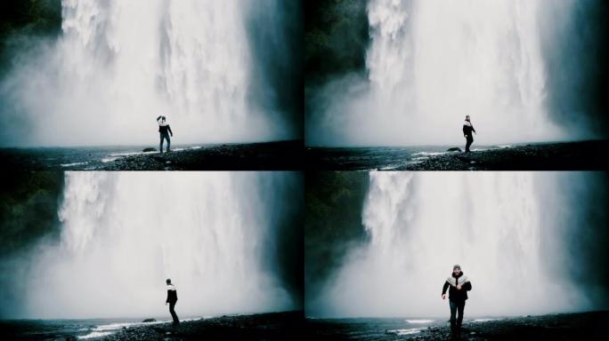 年轻英俊的男人独自走在冰岛强大的gljufragui瀑布附近，欣赏风景。