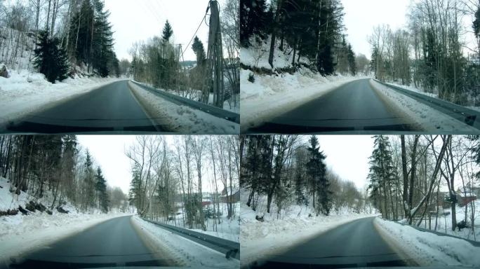 冬季驾驶中雪路的汽车挡风玻璃透视驾驶员的观点