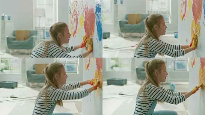 快乐的小女孩用手蘸上五颜六色的颜料在墙上画了一颗生动的心。她玩得很开心，笑得很开心。家正在装修。